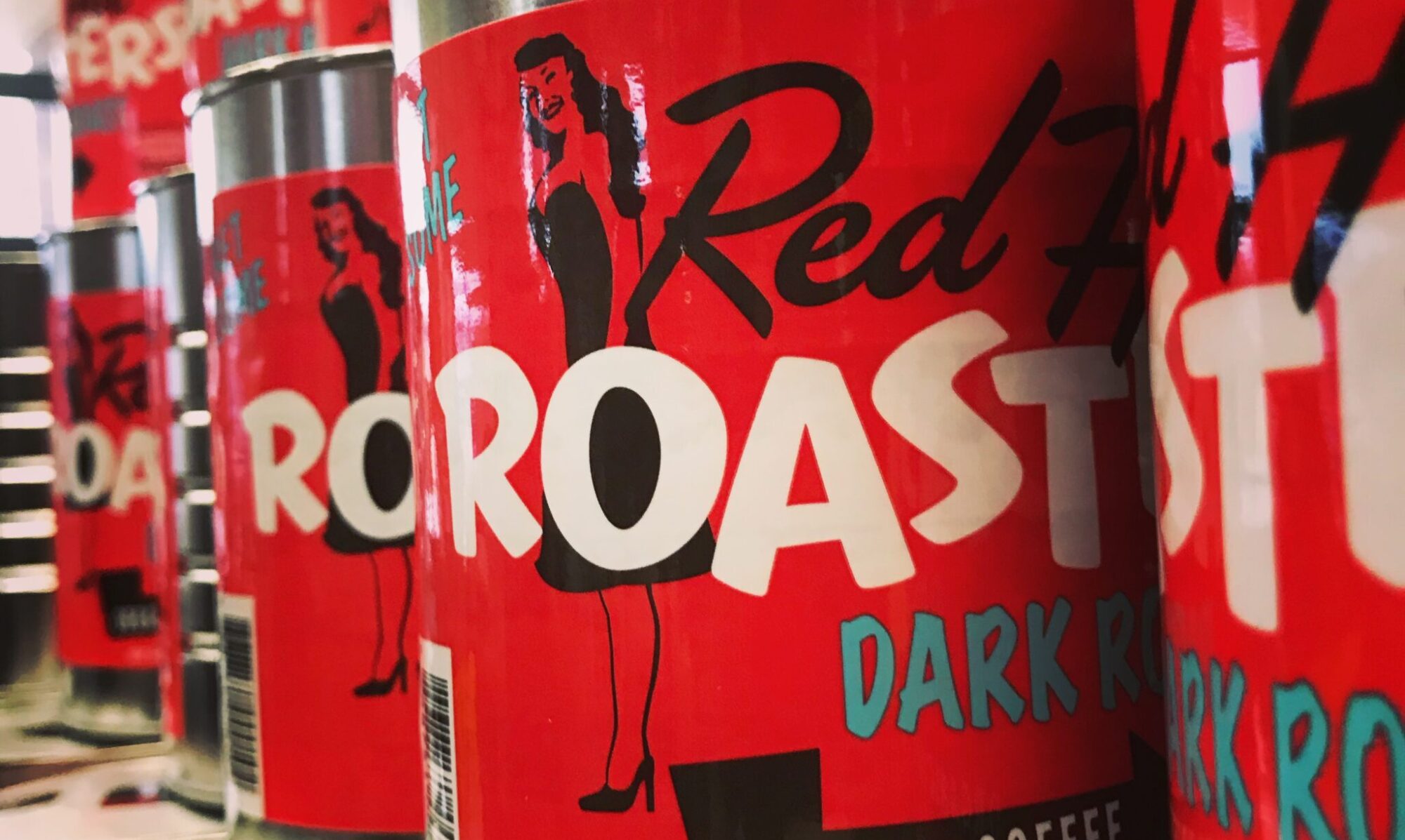 Red Hot Roasters coffee cans stacked in rows.